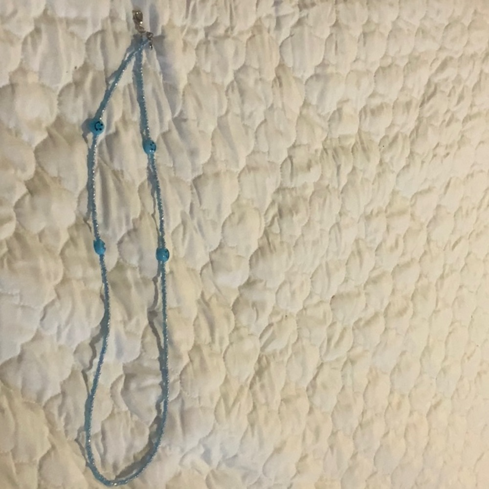 i am selling a blue smiley face necklace.